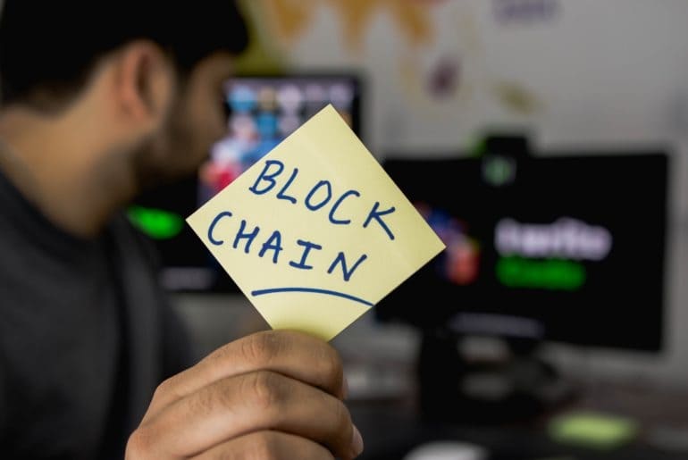 blockchain being held up by a man